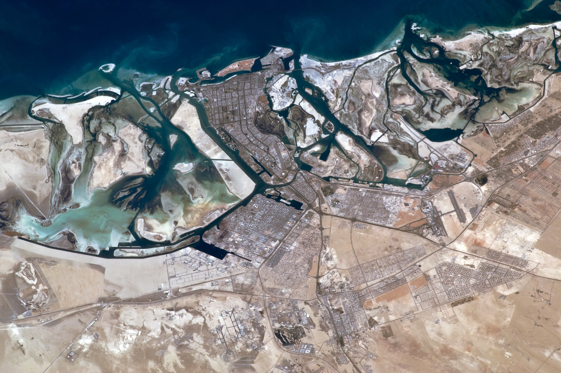 Aerial view of Abu Dhabi from space showing the islands and coastline
